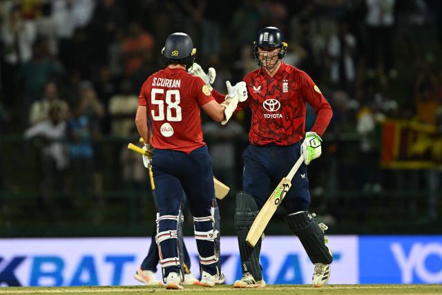 England's Tom Banton (R) and Sam Curran celebrates after winning during the second Twenty20 international cricket match between Sri Lanka and England at the Pallekele International Cricket Stadium in Kandy on February 1, 2026. (Photo by Ishara S. KODIKARA / AFP)