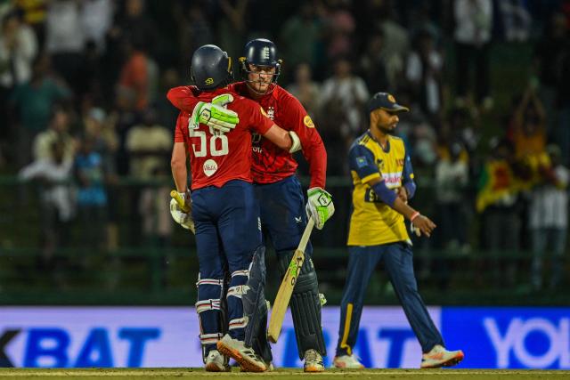 England's Tom Banton (C) and Sam Curran celebrates after winning during the second Twenty20 international cricket match between Sri Lanka and England at the Pallekele International Cricket Stadium in Kandy on February 1, 2026. (Photo by Ishara S. KODIKARA / AFP)