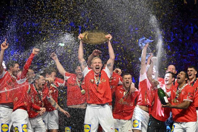 Denmark's team celebrates with the trophy after winning the Men's EHF Euro 2026 final handball match Denmark vs Germany in Herning, Denmark, on February 1, 2026. (Photo by Jonathan Nackstrand / AFP)