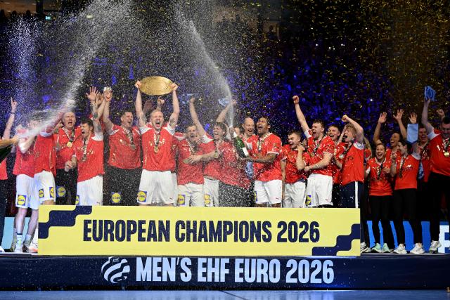 Denmark's team celebrates with the trophy after winning the Men's EHF Euro 2026 final handball match Denmark vs Germany in Herning, Denmark, on February 1, 2026. (Photo by Jonathan Nackstrand / AFP)