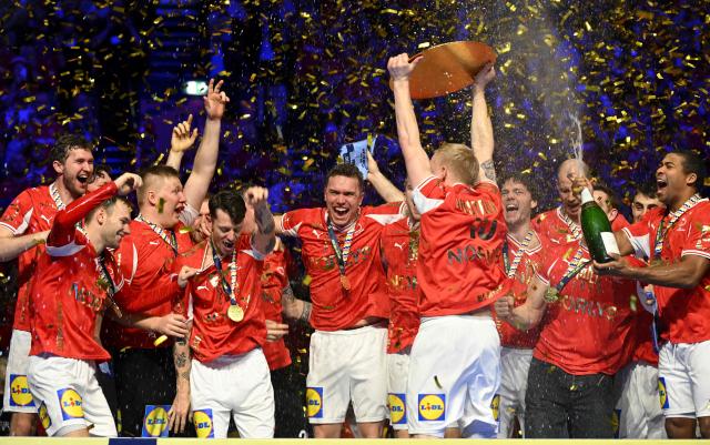 Denmark's team celebrates with champagne and the trophy after winning the Men's EHF Euro 2026 final handball match Denmark vs Germany in Herning, Denmark, on February 1, 2026. (Photo by Jonathan Nackstrand / AFP)