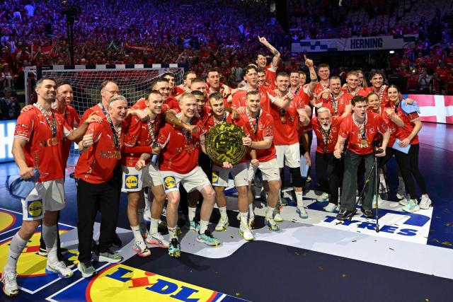 Denmark's coach Nikolaj Jacobsen (3L) poses with Denmark's team as they celebrate winning the Men's EHF Euro 2026 final handball match Denmark vs Germany in Herning, Denmark, on February 1, 2026. (Photo by Jonathan Nackstrand / AFP)