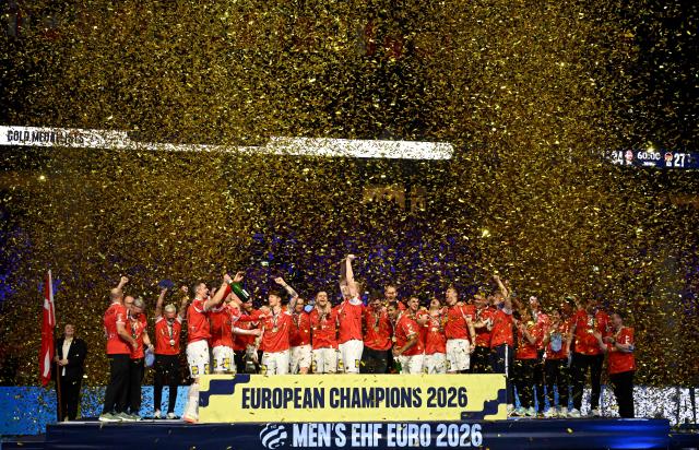 Denmark's players celebrate with the trophy after winning the Men's EHF Euro 2026 final handball match Denmark vs Germany in Herning, Denmark, on February 1, 2026. (Photo by Jonathan Nackstrand / AFP)