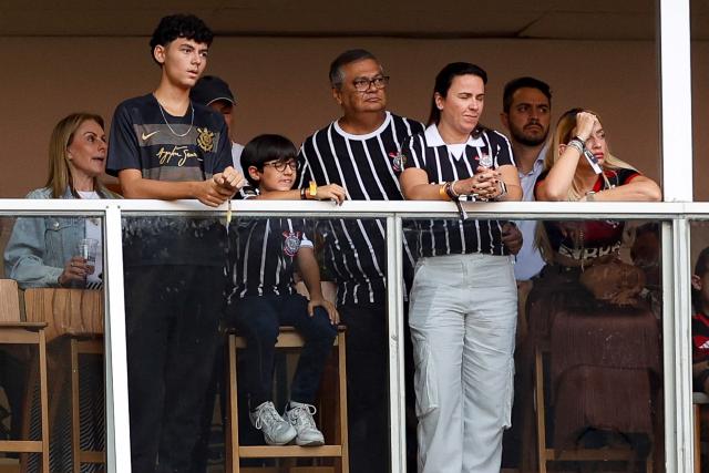 Brazil's Federal Supreme Court (STF) minister Flavio Dino (C) attends the Supercopa do Brasil 2026 final football match between Flamengo and Corinthians at the Arena BRB Mane Garrincha stadium in Brasilia on February 1, 2026. (Photo by Sergio Lima / AFP)