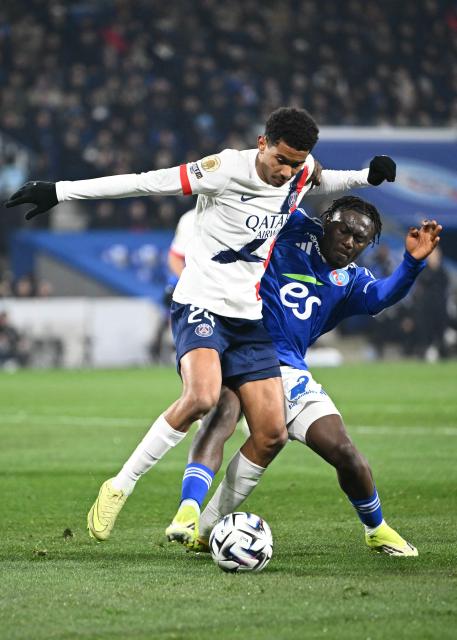 Paris Saint-Germain's French midfielder #24 Senny Mayulu (L) fights for the ball with Strasbourg's Ivorian forward #42 Abdoul Ouattara during the French L1 football match between RC Strasbourg Alsace and Paris Saint-Germain (PSG) at the Stade de la Meinau in Strasbourg, eastern France, on February 1, 2026. (Photo by SEBASTIEN BOZON / AFP)