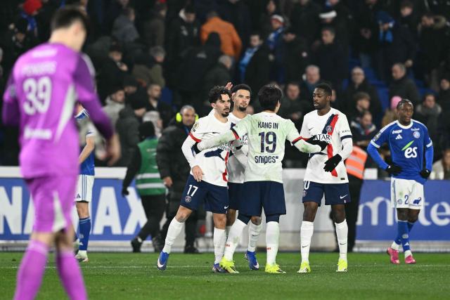 PSG players including Paris Saint-Germain's Portuguese midfielder #17 Vitinha, Paris Saint-Germain's French midfielder #33 Warren Zaire-Emery, Paris Saint-Germain's South Korean midfielder #19 Lee Kang-in and Paris Saint-Germain's French forward #10 Ousmane Dembele celebrate winning the French L1 football match between RC Strasbourg Alsace and Paris Saint-Germain (PSG) at the Stade de la Meinau in Strasbourg, eastern France, on February 1, 2026. (Photo by SEBASTIEN BOZON / AFP)