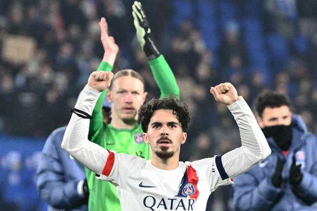 Paris Saint-Germain's Russian goalkeeper #39 Matvey Safonov and Paris Saint-Germain's Portuguese midfielder #17 Vitinha celebrate winning the French L1 football match between RC Strasbourg Alsace and Paris Saint-Germain (PSG) at the Stade de la Meinau in Strasbourg, eastern France, on February 1, 2026. (Photo by SEBASTIEN BOZON / AFP)