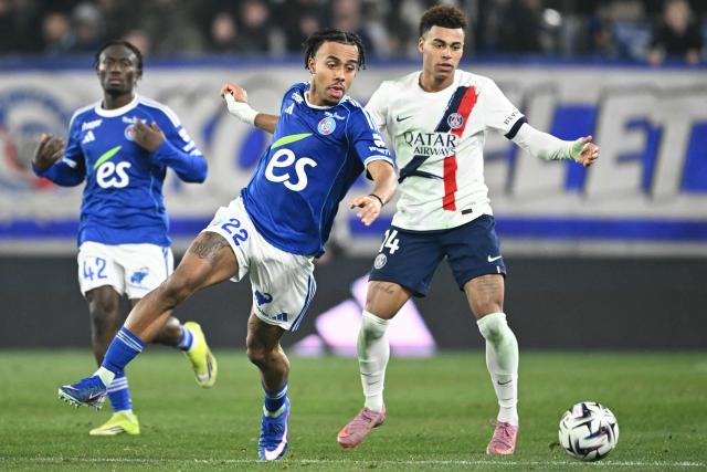 Strasbourg's Ivorian defender #22 Guela Doue (C) fights for the ball with Paris Saint-Germain's French midfielder #14 Desire Doue during the French L1 football match between RC Strasbourg Alsace and Paris Saint-Germain (PSG) at the Stade de la Meinau in Strasbourg, eastern France, on February 1, 2026. (Photo by SEBASTIEN BOZON / AFP)