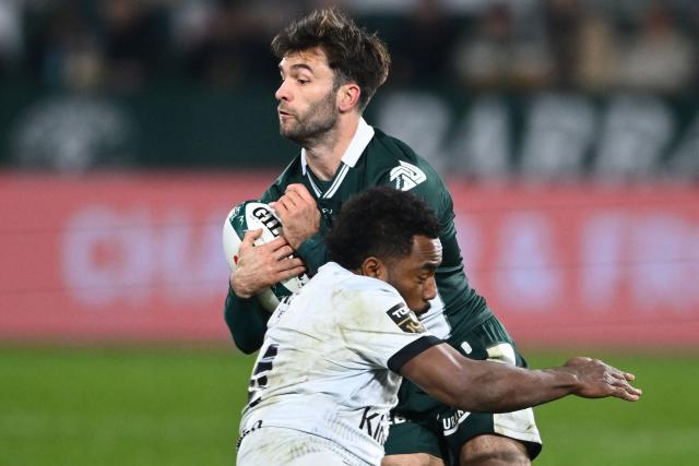 Pau's French fullback Aymeric Luc is tackled by Toulon's Fijian winger Setariki Tuicuvu during the French Top14 rugby union match between Section Paloise Bearn Pyrenees (Pau) and Racing Club Toulon at Stade du Hameau stadium in Pau, south-western France on February 1, 2026. (Photo by Gaizka IROZ / AFP)