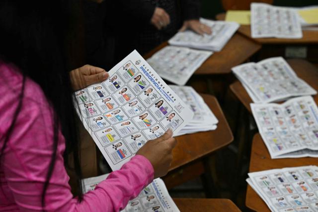 An election official prepares to start counting votes after polls closed at the La Escuela Pilar Jimenez school polling station during the presidential election in San Jose on February 1, 2026. Voters in Costa Rica, a beacon of stability in Central America threatened by a surge in drug-related violence, went to the polls in general elections that are expected to bring a tough-on-crime right-winger to power. (Photo by Marvin RECINOS / AFP)