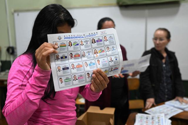 An election official shows a ballot as she counts votes after polls closed at the Pilar Jimenez school polling station during the presidential election in San Jose on February 1, 2026. Voters in Costa Rica, a beacon of stability in Central America threatened by a surge in drug-related violence, went to the polls in general elections that are expected to bring a tough-on-crime right-winger to power. (Photo by MARVIN RECINOS / AFP)