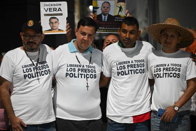 (L to R) Carlos Julio Rojas, human rights activist Javier Tarazona, Guillermo Lopez and Carlos Azuaje attend a demonstration demanding the release of political prisoners outside the El Helicoide building, headquarters of the Bolivarian National Intelligence Service (SEBIN), in Caracas on February 1, 2026. Renowned Venezuelan human rights activist Javier Tarazona was freed on February 1st after more than four years in prison on charges including terrorism and treason, his brother told AFP. (Photo by Federico PARRA / AFP)
