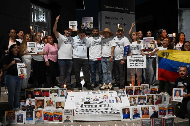 (6th from L) Carlos Julio Rojas, human rights activist Javier Tarazona, Guillermo Lopez, Carlos Azuaje, and Victor Castillo attend a demonstration demanding the release of political prisoners outside the El Helicoide building, headquarters of the Bolivarian National Intelligence Service (SEBIN), in Caracas on February 1, 2026. Renowned Venezuelan human rights activist Javier Tarazona was freed on February 1st after more than four years in prison on charges including terrorism and treason, his brother told AFP. (Photo by Federico PARRA / AFP)