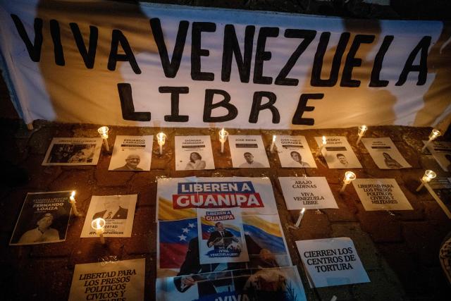 Relatives of political prisoner Juan Pablo Guanipa take part in a vigil in front of Plaza La Republica in Maracaibo, Zulia state, Venezuela, on February 1, 2026. Venezuela's acting president announced on January 30 a proposal for mass amnesty in the country, in her latest major reform since the US toppling of Nicolas Maduro just weeks ago. (Photo by Maryorin Mendez / AFP)