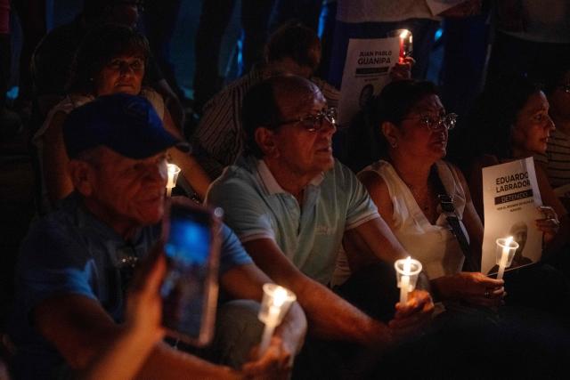 Relatives of political prisoner Juan Pablo Guanipa take part in a vigil in front of Plaza La Republica in Maracaibo, Zulia state, Venezuela, on February 1, 2026. Venezuela's acting president announced on January 30 a proposal for mass amnesty in the country, in her latest major reform since the US toppling of Nicolas Maduro just weeks ago. (Photo by Maryorin Mendez / AFP)