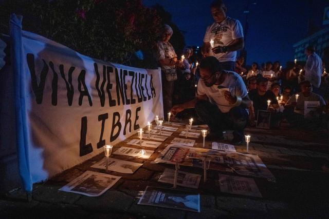 Relatives of political prisoner Juan Pablo Guanipa take part in a vigil in front of Plaza La Republica in Maracaibo, Zulia state, Venezuela, on February 1, 2026. Venezuela's acting president announced on January 30 a proposal for mass amnesty in the country, in her latest major reform since the US toppling of Nicolas Maduro just weeks ago. (Photo by Maryorin Mendez / AFP)