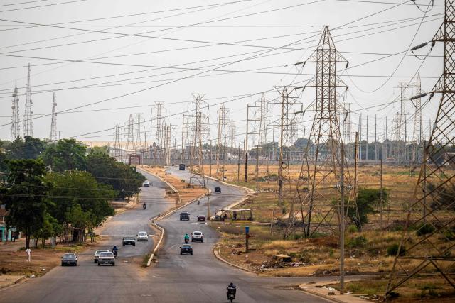 This view shows electrical towers on one of the streets in Maracaibo, Venezuela on February 1, 2026. Venezuelan interim President Delcy Rodriguez of oil-rich Venezuela said on January 30, 2026, she had agreed on energy cooperation with India, a day after Caracas opened its hydrocarbons sector to private companies. (Photo by Maryorin Mendez / AFP)