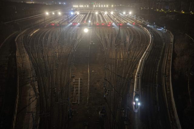 High-speed trains are seen at a train station on the first day of the annual Chunyun Spring Festival travel period,  in Nanjing, in China’s eastern Jiangsu province on February 2, 2026. (Photo by AFP) / China OUT