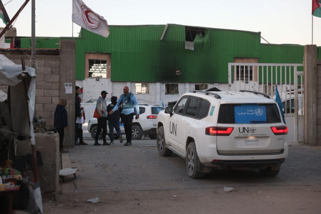 World Health Organisation vehicles leave the Red Crescent center as Palestinian patients and war-wounded, are escorted towards the Kerem Shalom crossing to leave the Gaza Strip for treatment abroad, in Khan Yunis in the southern Gaza Strip, on February 2, 2026. Israeli state broadcaster Kan reported that around 150 people were expected to leave Gaza for Egypt on February 2, including 50 patients. The report said around 50 people were also expected to enter the territory. (Photo by Bashar Taleb / AFP)