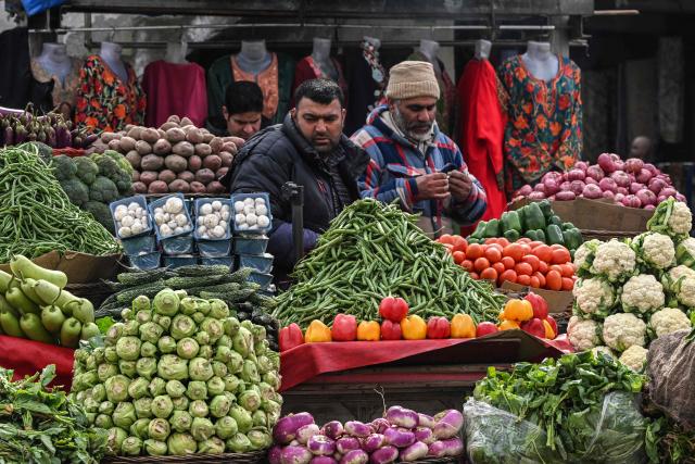 Vendors selling vegetables wait for customers in Srinagar on February 2, 2026. (Photo by Tauseef MUSTAFA / AFP)