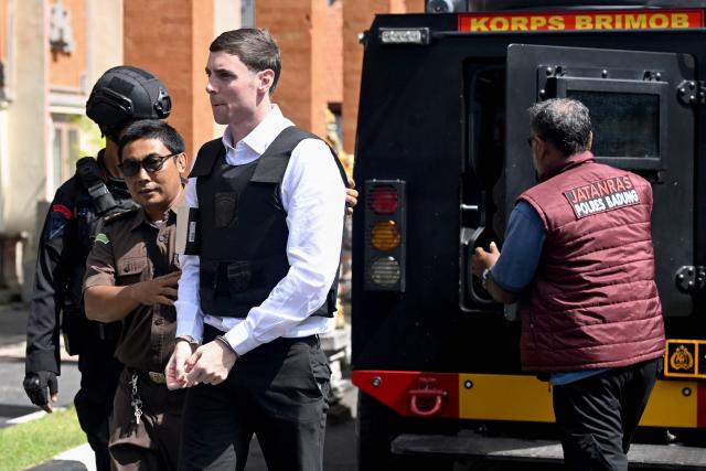 Australian suspect Darcy Francesco Jenson is brought to a holding cell for his trial at a court in Denpasar, Indonesia's Bali island, on February 2, 2026. The trial of three Australians accused of plotting the murder of a compatriot at a villa in Bali continues, with all facing the death penalty. (Photo by SONNY TUMBELAKA / AFP)