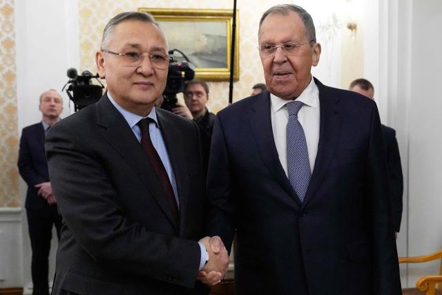 Russian Foreign Minister Sergei Lavrov and the newly appointed Secretary General of the Collective Security Treaty Organization (CSTO) Taalatbek Masadykov shake hands during their meeting at the Russian Foreign Ministry headquarters in Moscow on February 2, 2026. (Photo by Alexander Zemlianichenko / POOL / AFP)