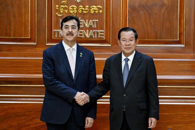 Cambodia's Senate President Hun Sen (R) shakes hands with Pakistan's Senate Chairman Yusuf Raza Gilani (L) at the Senate building in Phnom Penh on February 2, 2026. (Photo by TANG CHHIN Sothy / AFP)