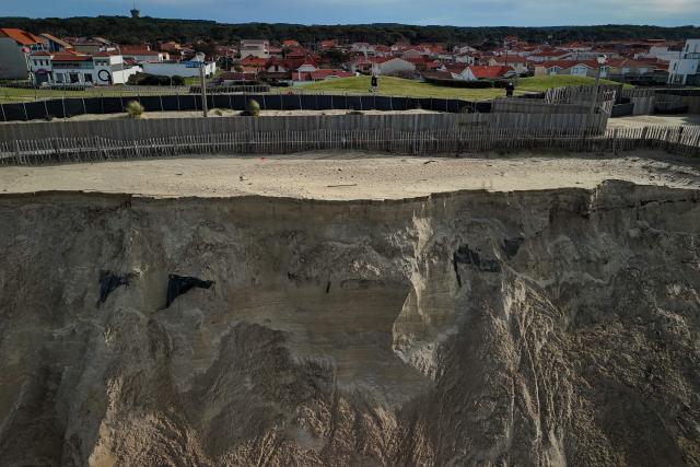 An aerial photograph shows damaged and collapsed sections of the Biscarrosse-Plage beachfront promenade in south-western France, on February 2, 2026. Approximately 50 meters of the beachfront concrete walkway and public benches collapsed into the Atlantic Ocean, leaving a gap along the Atlantic coast resort's beachfront infrastructure. (Photo by Philippe LOPEZ / AFP)