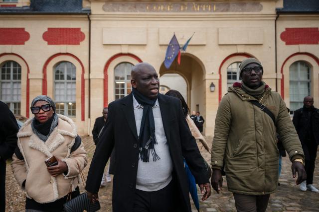 (FILES) Senegalese press magnate and government critic Madiambal Diagne (C) leaves after a hearing at the Versailles Court of Appeal, in Versailles on November 25, 2025 following the court's decision to temporarily block his extradition request. The court of appeal is to give its decision on February 3, 2026 on the extradition request for Madiambal Diagne, a critic of his country's government, after it was postponed in November 25 to request further details. (Photo by Dimitar DILKOFF / AFP)