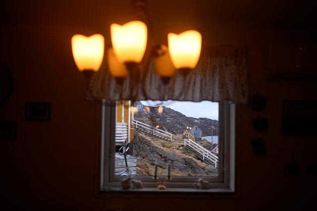 A view from the interior of a house on February 1, 2026 shows other houses at the settlement Sarfannguit, near Sisimiut, Greenland. Sarfannguit is a settlement in central-western Greenland, is located within the Aasivissuit  Nipisat UNESCO World Heritage Site, and was inscribed on the World Heritage List in 2018 for its outstanding archeological sites representing the human occupation of Greenland for over 4,000 years. Currently, approximately 50 residents live there.

Search for all these reportage images using: GREENLAND - DENMARK - HUNTING - SEALING. (Photo by Ina FASSBENDER / AFP)