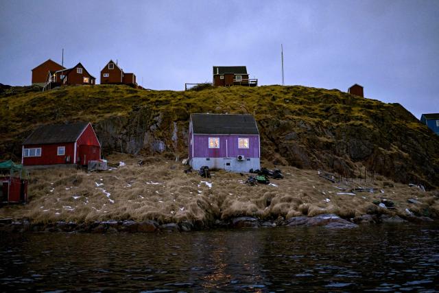 A photo taken on February 1, 2026 shows houses at the settlement Sarfannguit near Sisimiut, Greenland. Search for all these reportage images using: GREENLAND - DENMARK - HUNTING - SEALING. (Photo by Ina FASSBENDER / AFP)