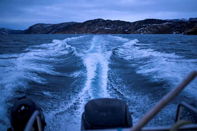 Waves form on the water as hunter and fisherman Malik Kleist drives his fishing boat in a fjord near Sarfannguit, near Sisimiut, Greenland on February 1, 2026. Search for all these reportage images using: GREENLAND - DENMARK - HUNTING - SEALING. (Photo by Ina FASSBENDER / AFP)