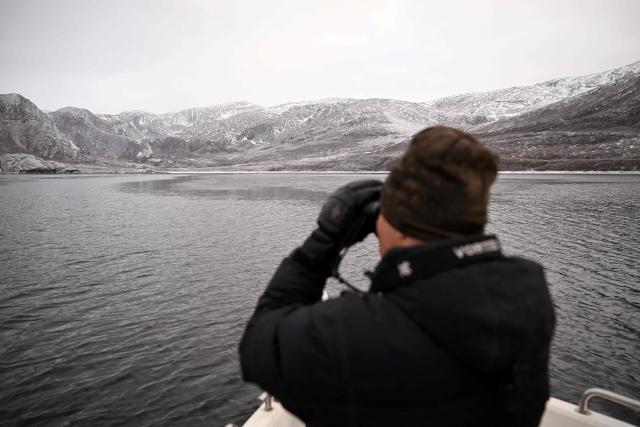 Hunter and fisherman Karl Joregn on his fishing boat searches for seals in a fjord near Sarfannguit, near Sisimiut, Greenland on February 1, 2026. Search for all these reportage images using: GREENLAND - DENMARK - HUNTING - SEALING. (Photo by Ina FASSBENDER / AFP)