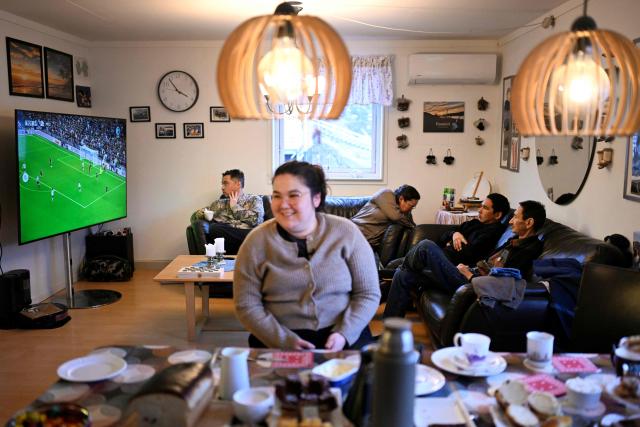 The family of teacher Camilla Olsen watches football at their home at the settlement Sarfannguit, near Sisimiut, Greenland on February 1, 2026. Sarfannguit is a settlement in central-western Greenland, is located within the Aasivissuit  Nipisat UNESCO World Heritage Site, and was inscribed on the World Heritage List in 2018 for its outstanding archeological sites representing the human occupation of Greenland for over 4,000 years. Currently, approximately 50 residents live there.

Search for all these reportage images using: GREENLAND - DENMARK - HUNTING - SEALING. (Photo by Ina FASSBENDER / AFP)