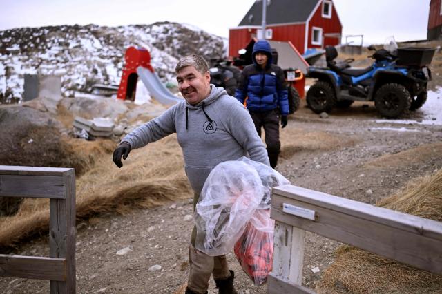 The husband of teacher Camilla Olsen arrives with a bag of seal meat at their home at the settlement Sarfannguit near Sisimiut, Greenland on February 1, 2026. Sarfannguit is a settlement in central-western Greenland, is located within the Aasivissuit  Nipisat UNESCO World Heritage Site, and was inscribed on the World Heritage List in 2018 for its outstanding archeological sites representing the human occupation of Greenland for over 4,000 years. Currently, approximately 50 residents live there.

Search for all these reportage images using: GREENLAND - DENMARK - HUNTING - SEALING. (Photo by Ina FASSBENDER / AFP)