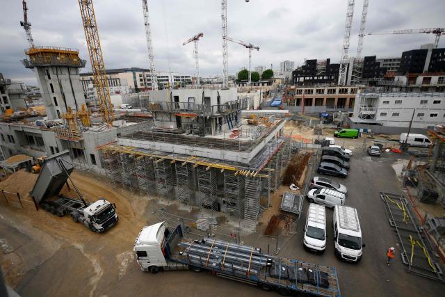 (FILES) This general view shows the 2024 Paris Olympic village construction site in Saint-Denis, north of Paris on May 23, 2022. A trial has started in Bobigny on the outskirts of Paris on February 2, 2026, of some 24 people and three companies suspected of having taken part in a vast network that illegally employed Malian workers to build the Paris 2024 Olympic village, one of Оle-de-France’s last flagship construction sites. (Photo by FRANCK FIFE / AFP)