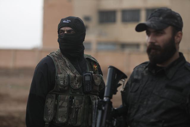 Kurdish security forces stand guard as Syrian government internal security forces enter the northeastern Syrian city of Hasakeh on February 2, 2026. Damascus and Kurdish forces reached a comprehensive agreement on on January 30,2026, to gradually integrate the Kurds' military and civilian institutions into the state, after the minority ceded territory to advancing government forces in recent weeks. (Photo by Bakr ALKASEM / AFP)