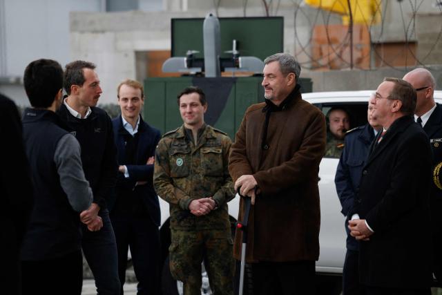 German Defence Minister Boris Pistorius (R) and Bavarian State Premier Markus Soeder (2R) visit the Innovation Center of the German Armed Forces Bundeswehr in Erding, Bavaria, southern Germany on February 2, 2026, on the day of the center's inauguration. (Photo by Michaela Stache / AFP)