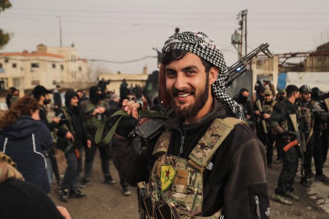 A member of the Kurdish forces reacts as Syrian government internal security forces enter the northeastern Syrian city of Hasakeh on February 2, 2026. Syrian government security personnel on February 2, 2026, entered Hasakeh city, a stronghold of Kurdish forces, under an integration deal agreed with the Kurds last week, an AFP team reported. The two sides reached a comprehensive agreement on January 30 to gradually integrate the Kurds' military and civilian institutions into the state, after Kurdish forces ceded territory to advancing government troops in recent weeks after months of tensions and sporadic clashes. (Photo by Delil SOULEIMAN / AFP)