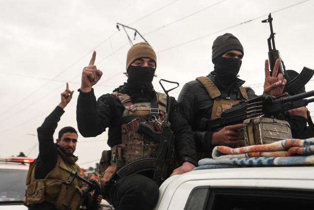 Syrian government internal security forces enter the northeastern Syrian city of Hasakeh on February 2, 2026. Syrian government security personnel on February 2, 2026, entered Hasakeh city, a stronghold of Kurdish forces, under an integration deal agreed with the Kurds last week, an AFP team reported. The two sides reached a comprehensive agreement on January 30 to gradually integrate the Kurds' military and civilian institutions into the state, after Kurdish forces ceded territory to advancing government troops in recent weeks after months of tensions and sporadic clashes. (Photo by Delil SOULEIMAN / AFP)