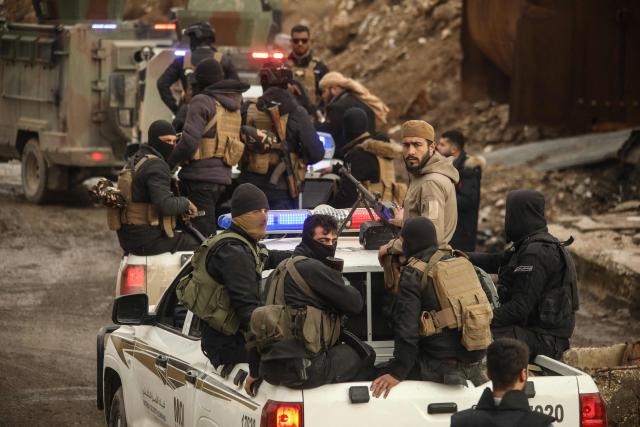 Syrian government internal security forces enter the northeastern Syrian city of Hasakeh on February 2, 2026. Syrian government security personnel on February 2, 2026, entered Hasakeh city, a stronghold of Kurdish forces, under an integration deal agreed with the Kurds last week, an AFP team reported. The two sides reached a comprehensive agreement on January 30 to gradually integrate the Kurds' military and civilian institutions into the state, after Kurdish forces ceded territory to advancing government troops in recent weeks after months of tensions and sporadic clashes. (Photo by Delil SOULEIMAN / AFP)