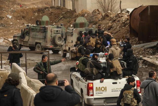 Syrian government internal security forces enter the northeastern Syrian city of Hasakeh on February 2, 2026. Syrian government security personnel on February 2, 2026, entered Hasakeh city, a stronghold of Kurdish forces, under an integration deal agreed with the Kurds last week, an AFP team reported. The two sides reached a comprehensive agreement on January 30 to gradually integrate the Kurds' military and civilian institutions into the state, after Kurdish forces ceded territory to advancing government troops in recent weeks after months of tensions and sporadic clashes. (Photo by Delil SOULEIMAN / AFP)