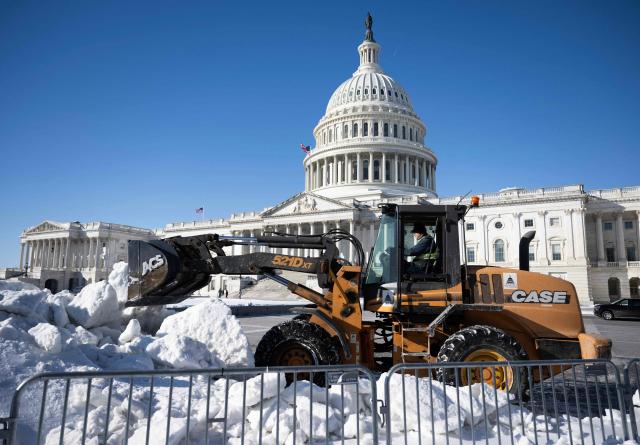 A worker clears snow outside the US Capitol in Washington, DC, on February 2, 2026. US House Speaker Mike Johnson expressed confidence on February 1 that he has the votes to end by Tuesday a partial government shutdown triggered by the Trump administration's violent immigration sweeps in Minneapolis. The government entered the shutdown Saturday as a funding deadline passed without Congress approving a 2026 budget. The impact so far appears to have been minimal. (Photo by ANDREW CABALLERO-REYNOLDS / AFP)
