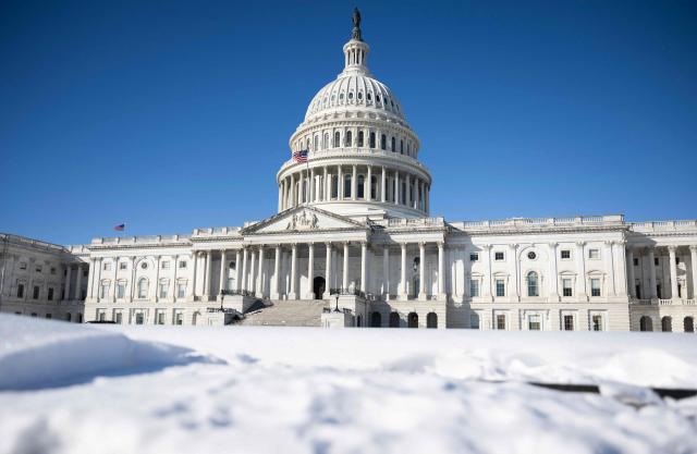 Snow is seen near the US Capitol in Washington, DC, on February 2, 2026. US House Speaker Mike Johnson expressed confidence on February 1 that he has the votes to end by Tuesday a partial government shutdown triggered by the Trump administration's violent immigration sweeps in Minneapolis. The government entered the shutdown Saturday as a funding deadline passed without Congress approving a 2026 budget. The impact so far appears to have been minimal. (Photo by ANDREW CABALLERO-REYNOLDS / AFP)