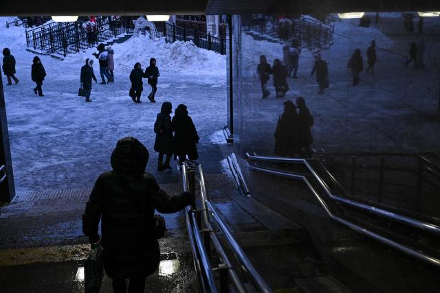 People walk next to a metro station in Moscow on February 2, 2026. (Photo by Hector RETAMAL / AFP)