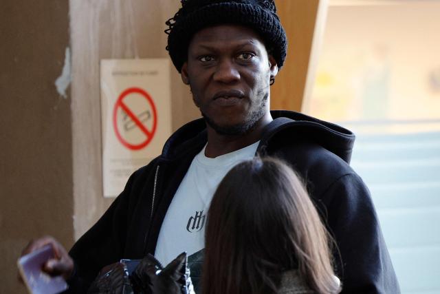 French rapper Doums, also known as Mamadou Coulibaly, arrives for his trial for violence against his partner at the Creteil courthouse, a suburb east of Paris, on February 2, 2026. (Photo by GEOFFROY VAN DER HASSELT / AFP)