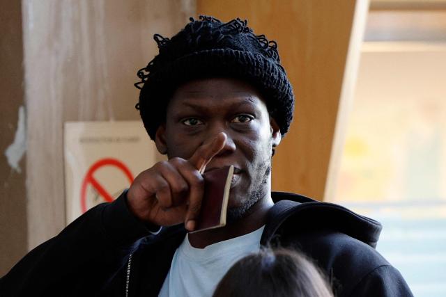 French rapper Doums, also known as Mamadou Coulibaly, arrives for his trial for violence against his partner at the Creteil courthouse, a suburb east of Paris, on February 2, 2026. (Photo by GEOFFROY VAN DER HASSELT / AFP)