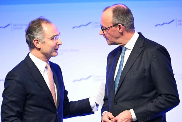 German Chancellor Friedrich Merz (R) after delivering a speech chats with Chairman of the Executive Board of Deutsche Boerse Group, Austrian Stephan Leithner at the annual reception of the stock exchange operator Deutsche Boerse in Eschborn, western Germany, on February 2, 2026. (Photo by Kirill KUDRYAVTSEV / AFP)