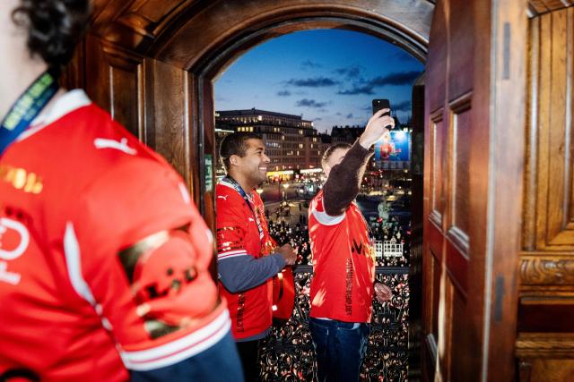 Denmark's men's handball team Mads Svane and Mads Mensah celebrate as European champions on the balcony at the Copenhagen City Hall in Copenhagen, Denmark on February 2, 2026, after the team won gold at the Men's EHF Euro 2026 final handball match Denmark vs Germany. (Photo by Sebastian Elias Uth / Ritzau Scanpix / AFP) / Denmark OUT