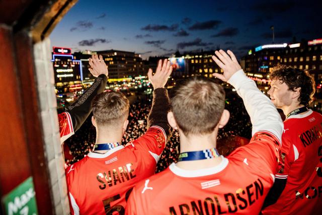 Denmark's men's handball team Mads Svane, Thomas Arnoldsen, and Niclas Kirkeloekke celebrate as European champions on the balcony at the Copenhagen City Hall in Copenhagen, Denmark on February 2, 2026, after the team won gold at the Men's EHF Euro 2026 final handball match Denmark vs Germany. (Photo by Sebastian Elias Uth / Ritzau Scanpix / AFP) / Denmark OUT